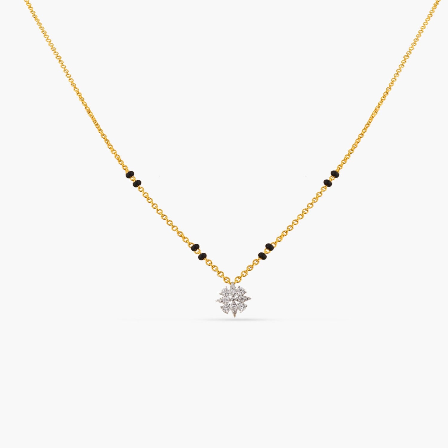 A picture of a gold plated silver chain with black beads and a flower pendant, featuring Cubic Zirconia on a white background.