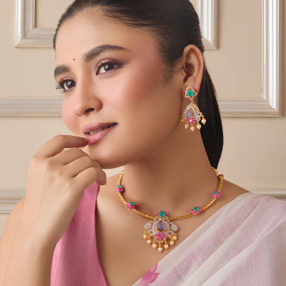 Woman wearing a colorful traditional gemstone necklace set with matching earrings