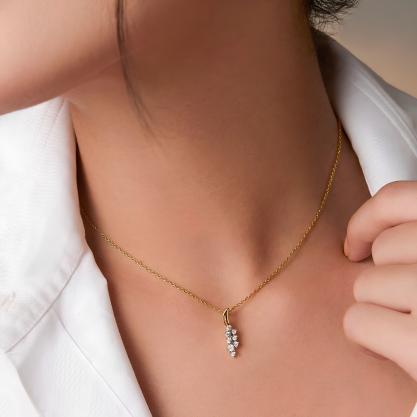A woman wearing a delicate silver pendant necklace.