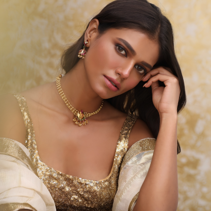 Woman wearing traditional jewellery and an embellished outfit.