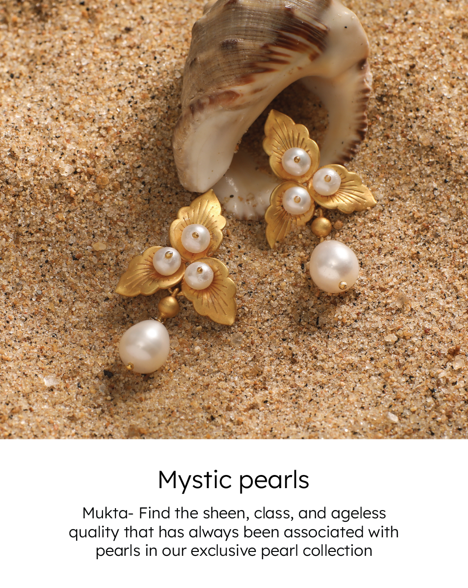 A close-up photo of a pair of vintage costume pearl earrings resting on a seashell. The text is showing, "Mystic Pearl. Mukta - find the sheen, class, ageless quality that has always been associated with pearls in our exclusive Pearl Collection.