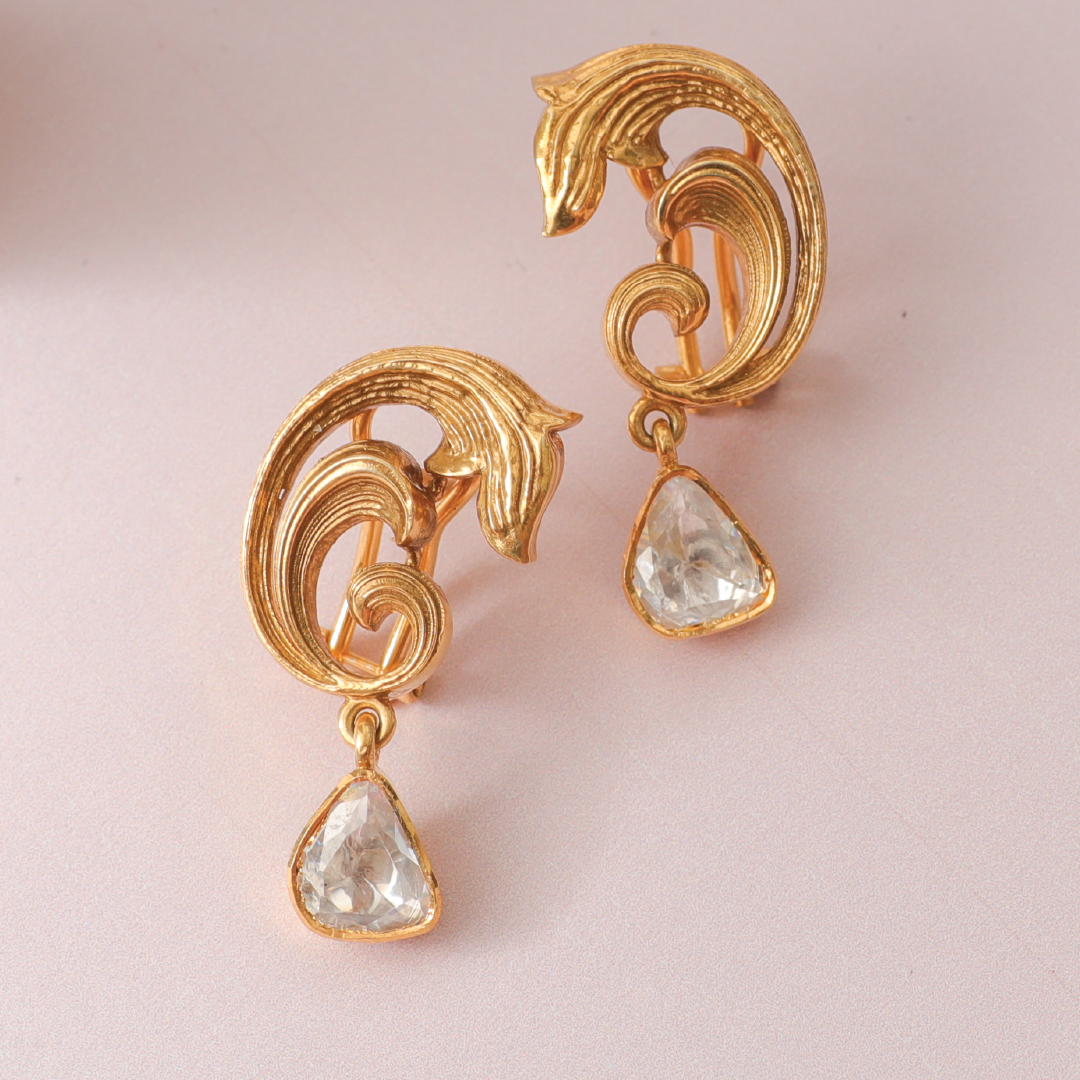 A picture of a pair of earrings with Moissanite gemstones.