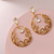 A picture of a pair of earrings with intricate Moissanite gemstones. 