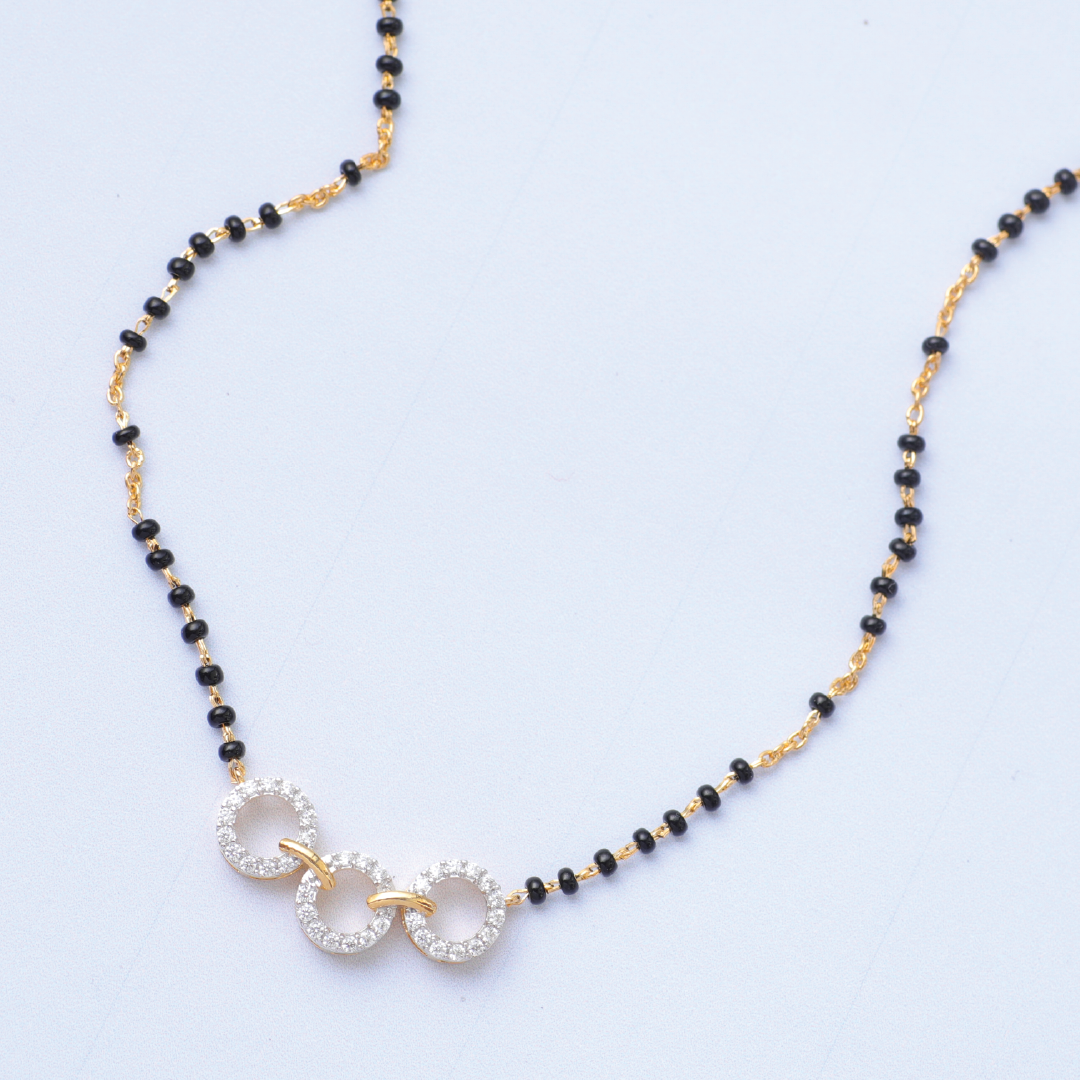 A picture of three-ring Mangalsutra with black beads and Cubic Zirconia.