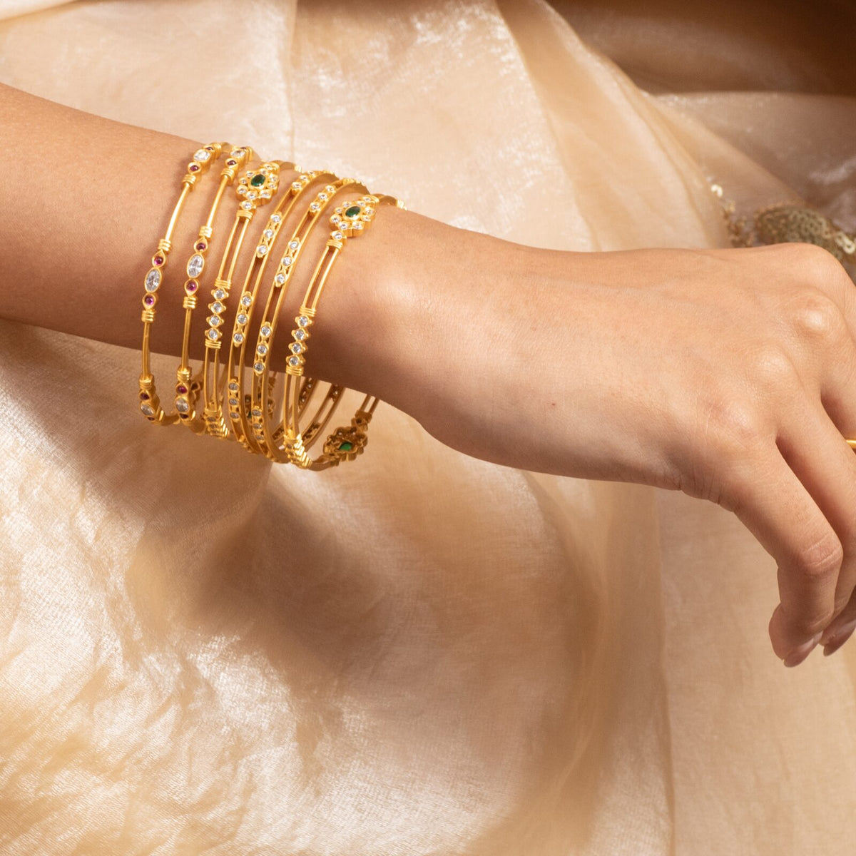 Stack of gold-plated silver bangles on a wrist