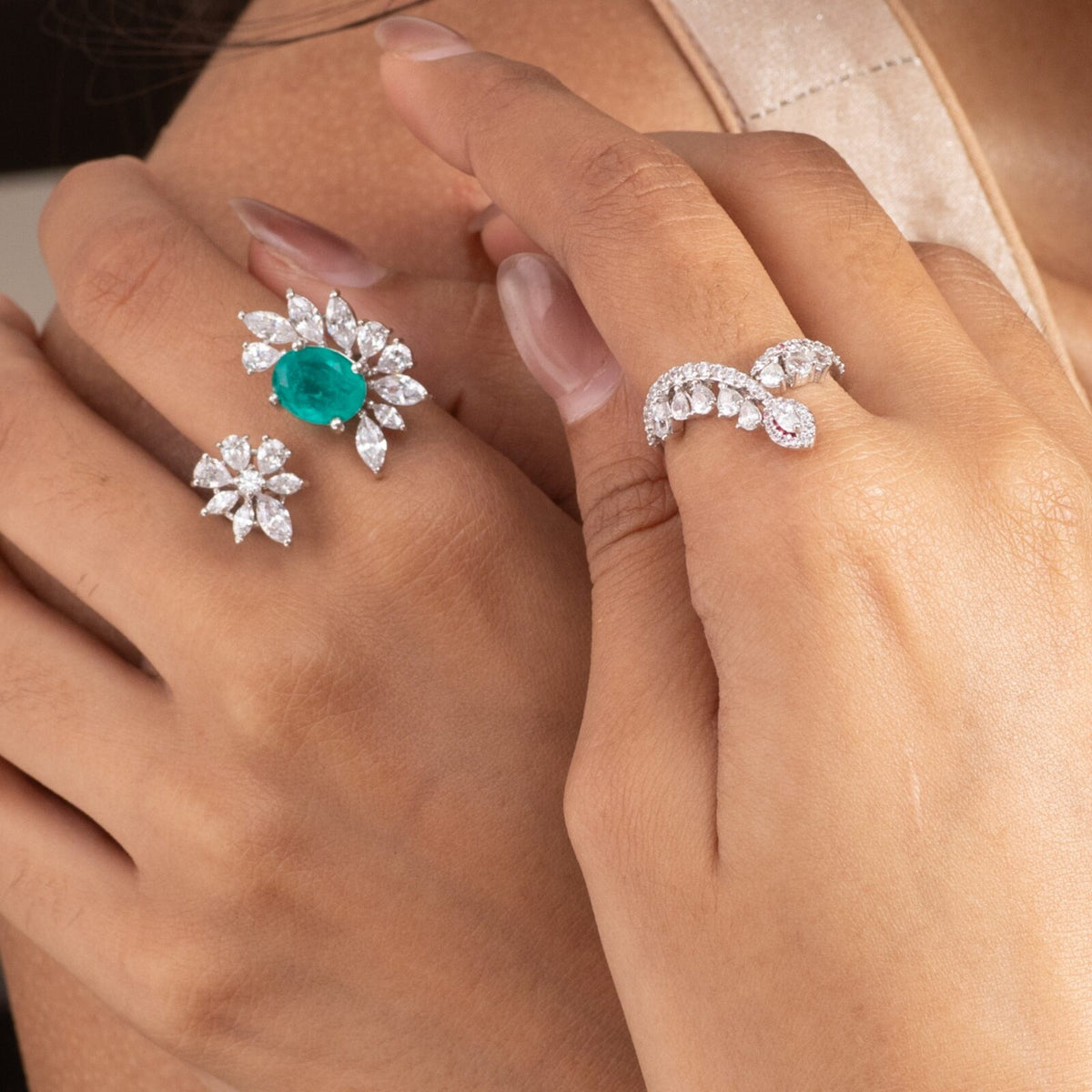 Silver cocktail rings with white and green stones, worn