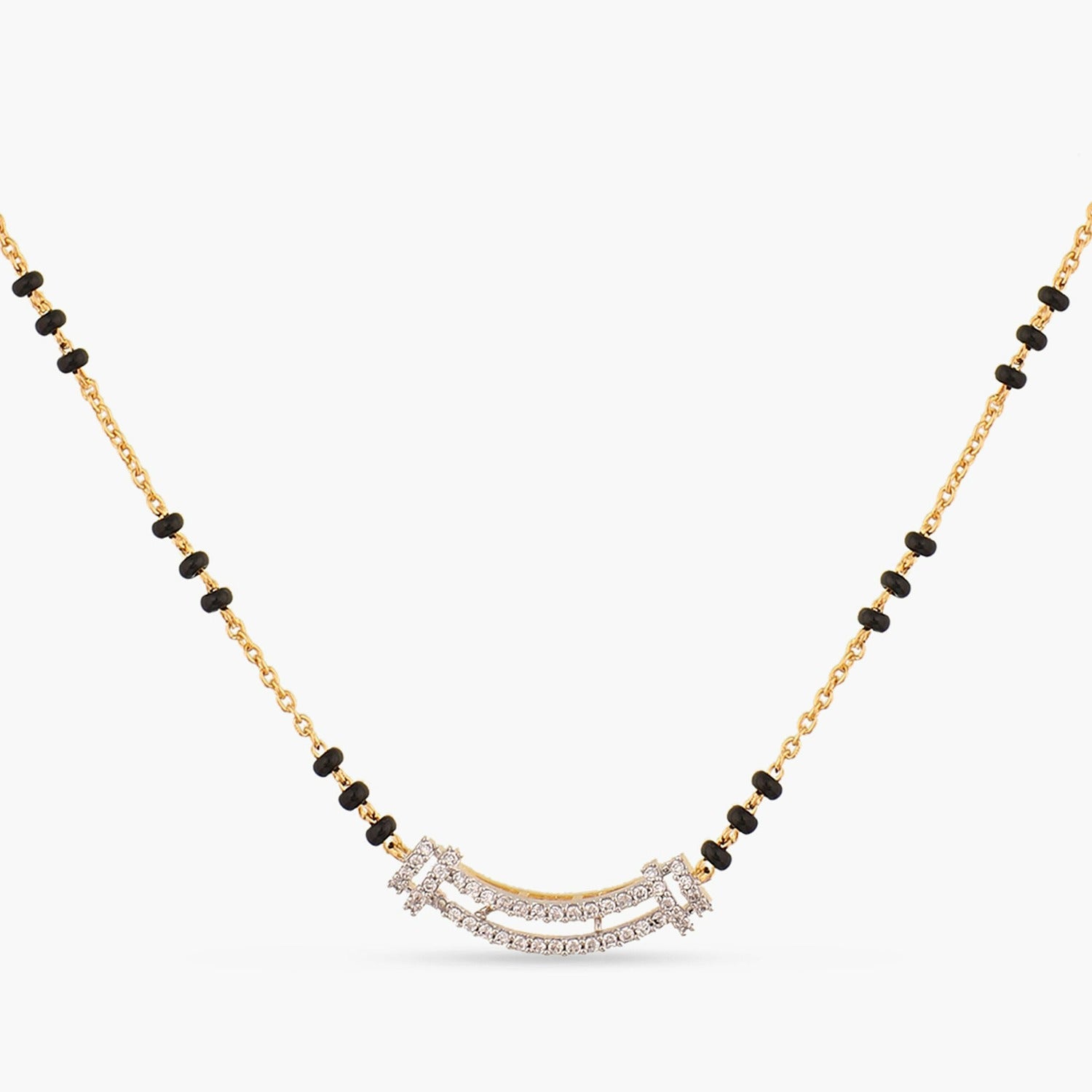 A picture of a silver mangalsutra with black beads and Cubic Zirconia resting on a white background.