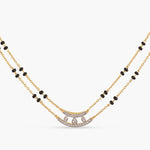 A picture of two layered silver chain with black beads and Cubic Zirconia resting on a white background.