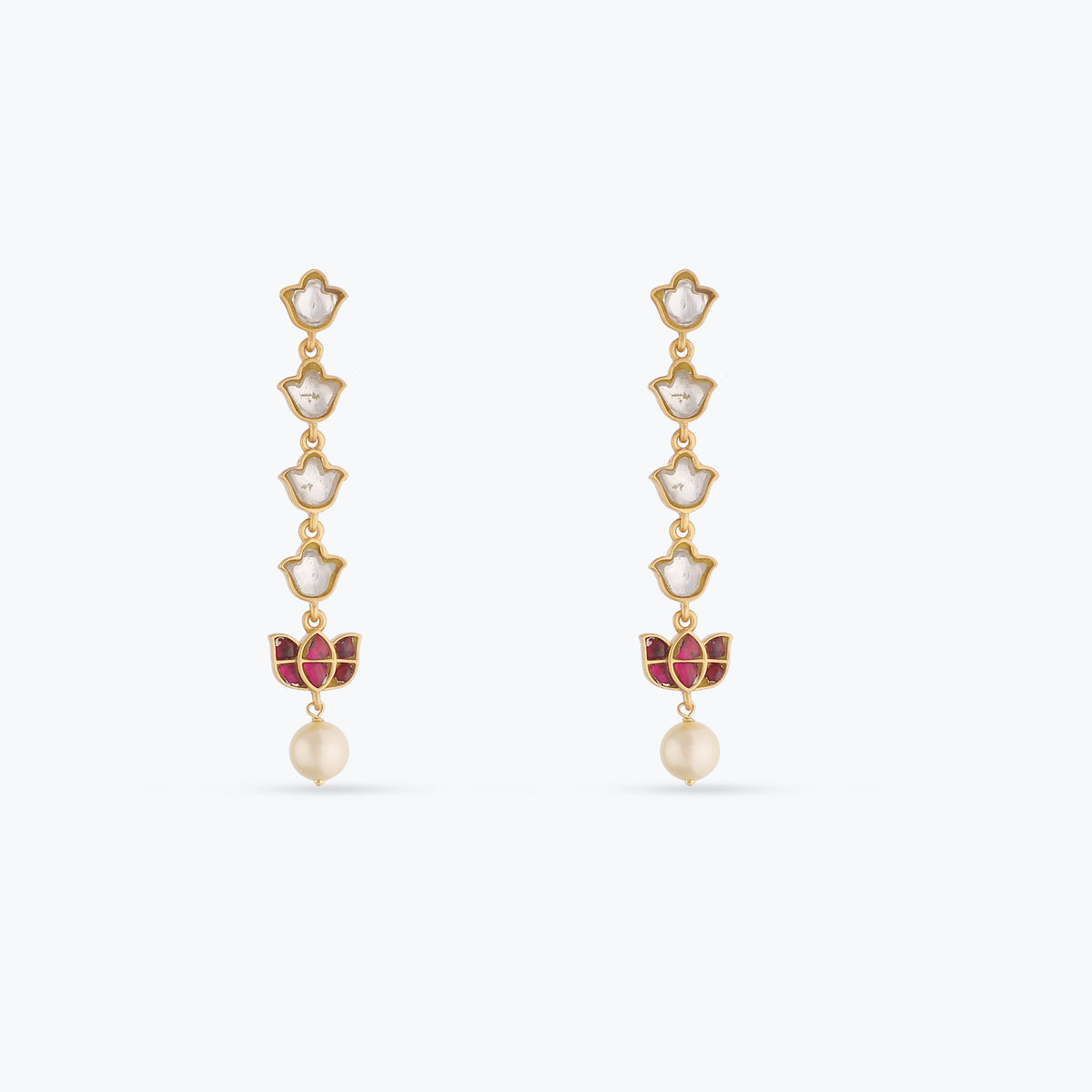 An image of a pair pf silver earrings with red and white jadau stones.