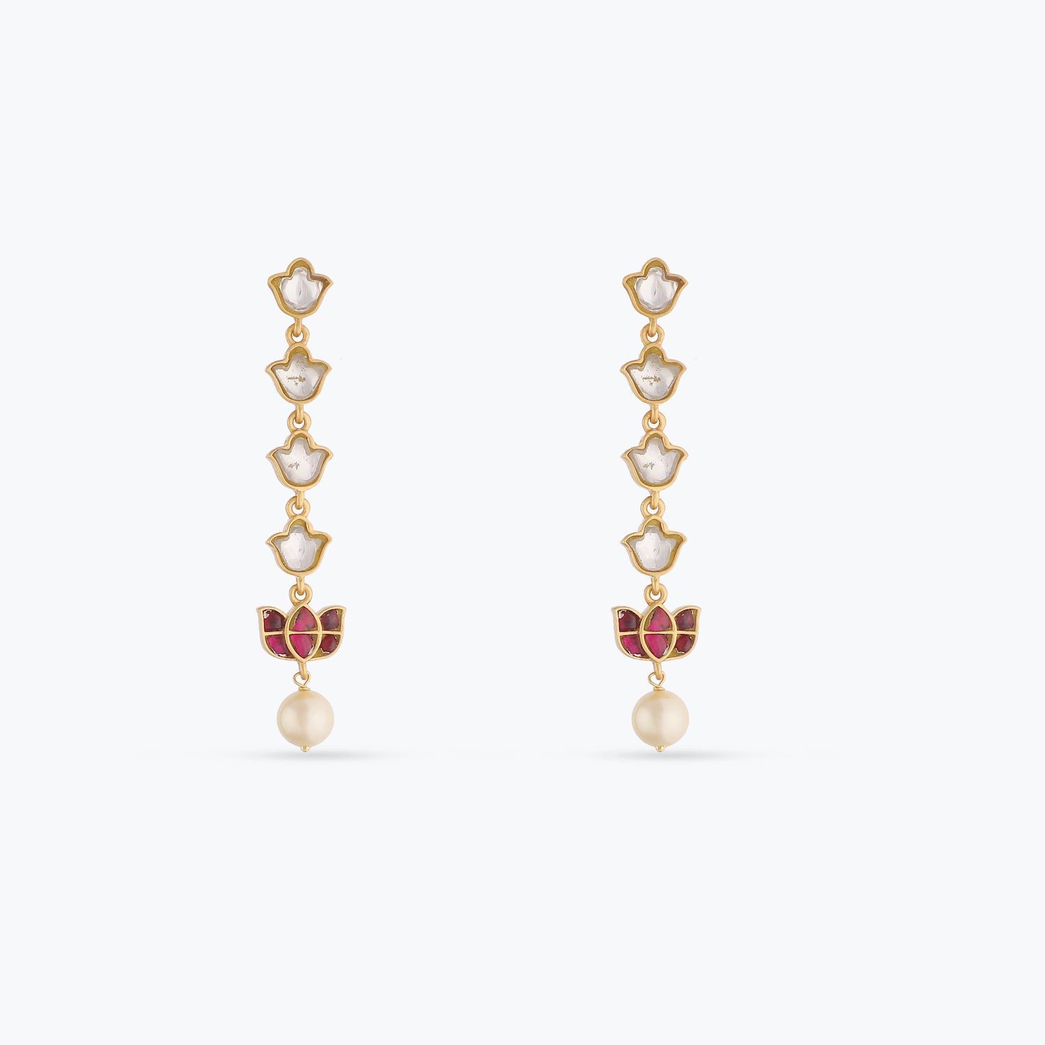 An image of a pair pf silver earrings with red and white jadau stones.