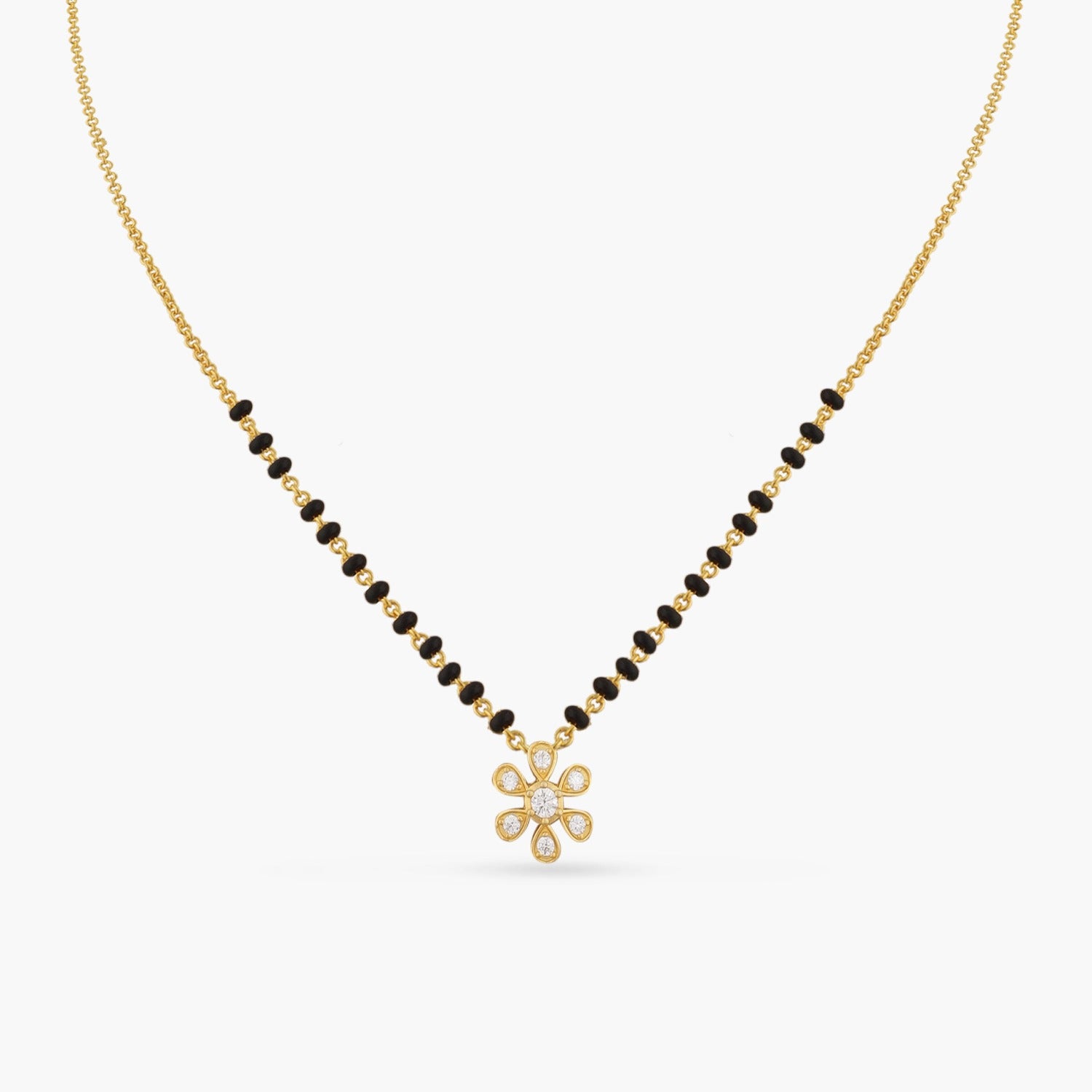 A picture of a silver mangalsutra chain with black beads and Cubic Zirconia floral pendant on a white background.