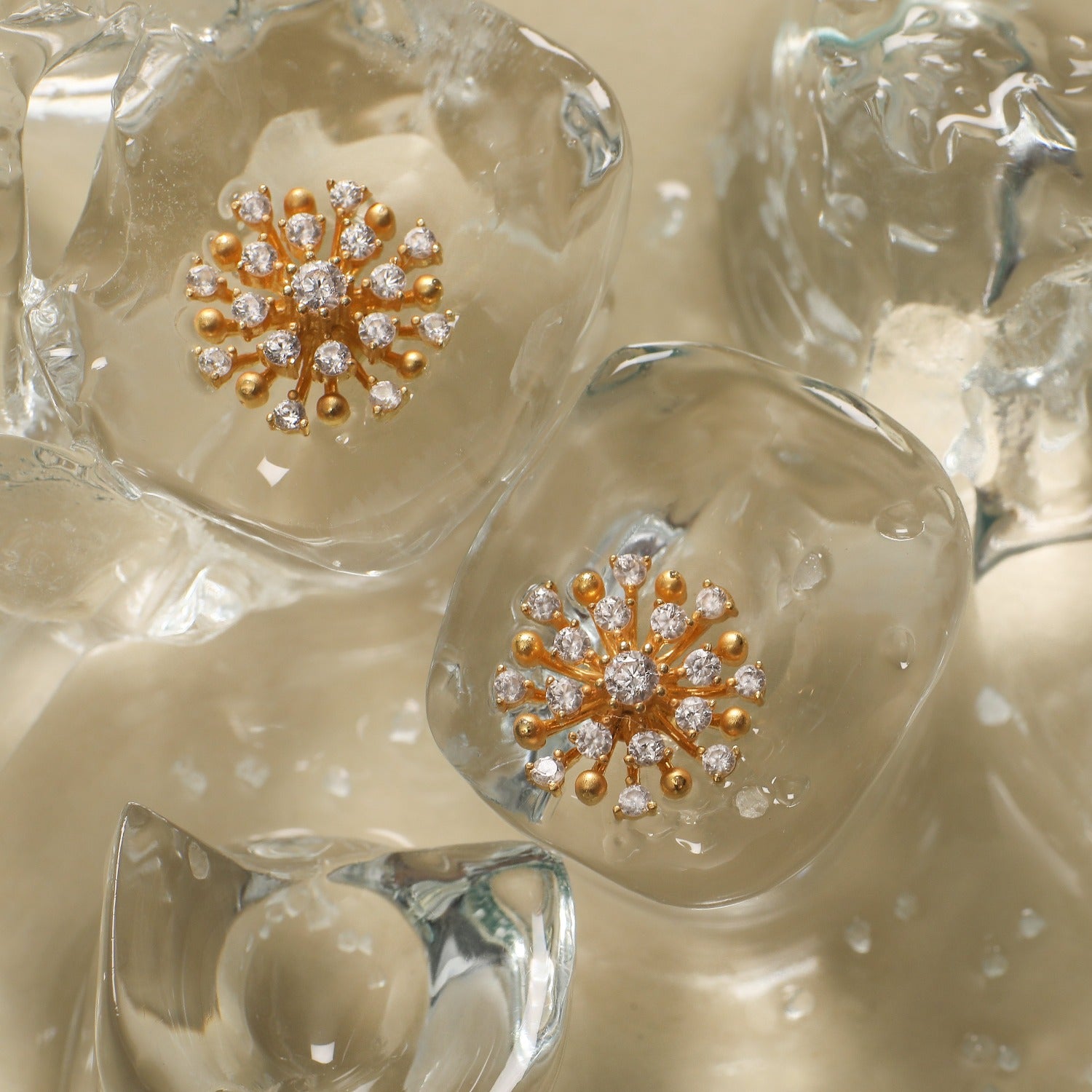 A picture of a pair of silver earrings with Cubic Zirconia stones in floral design.